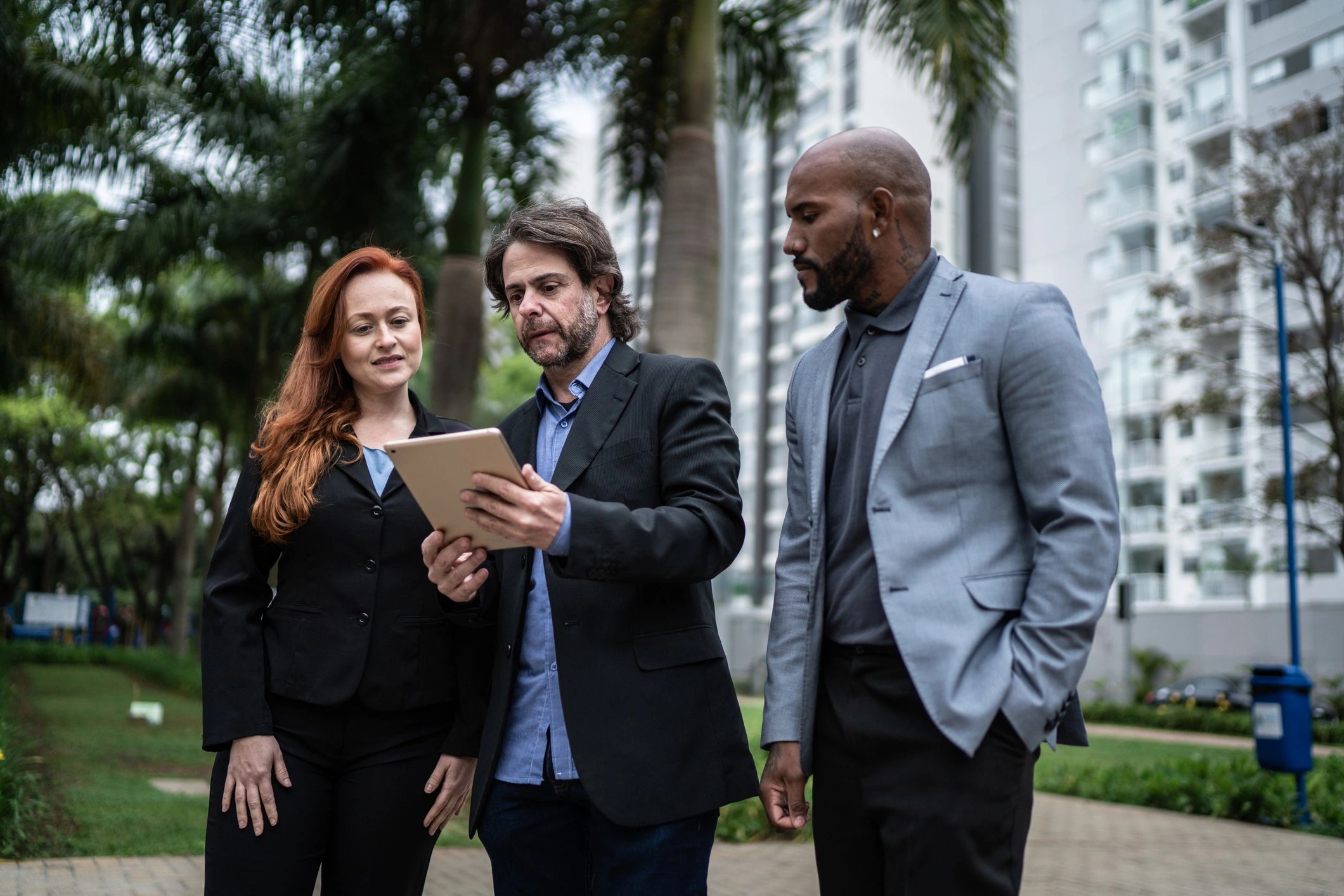 Business professionals meeting outdoors near a commercial property