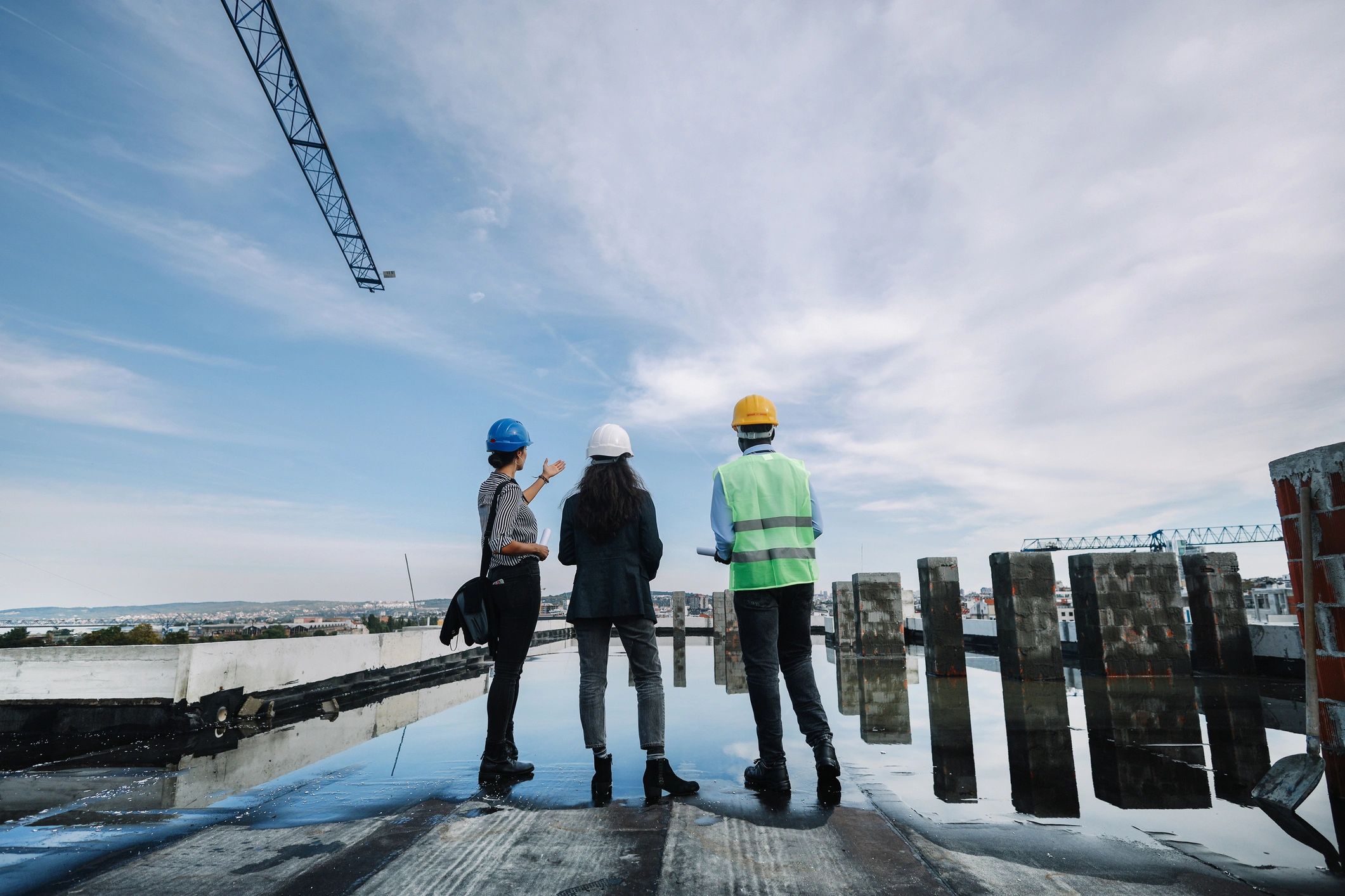 Real estate professionals reviewing a construction project on site