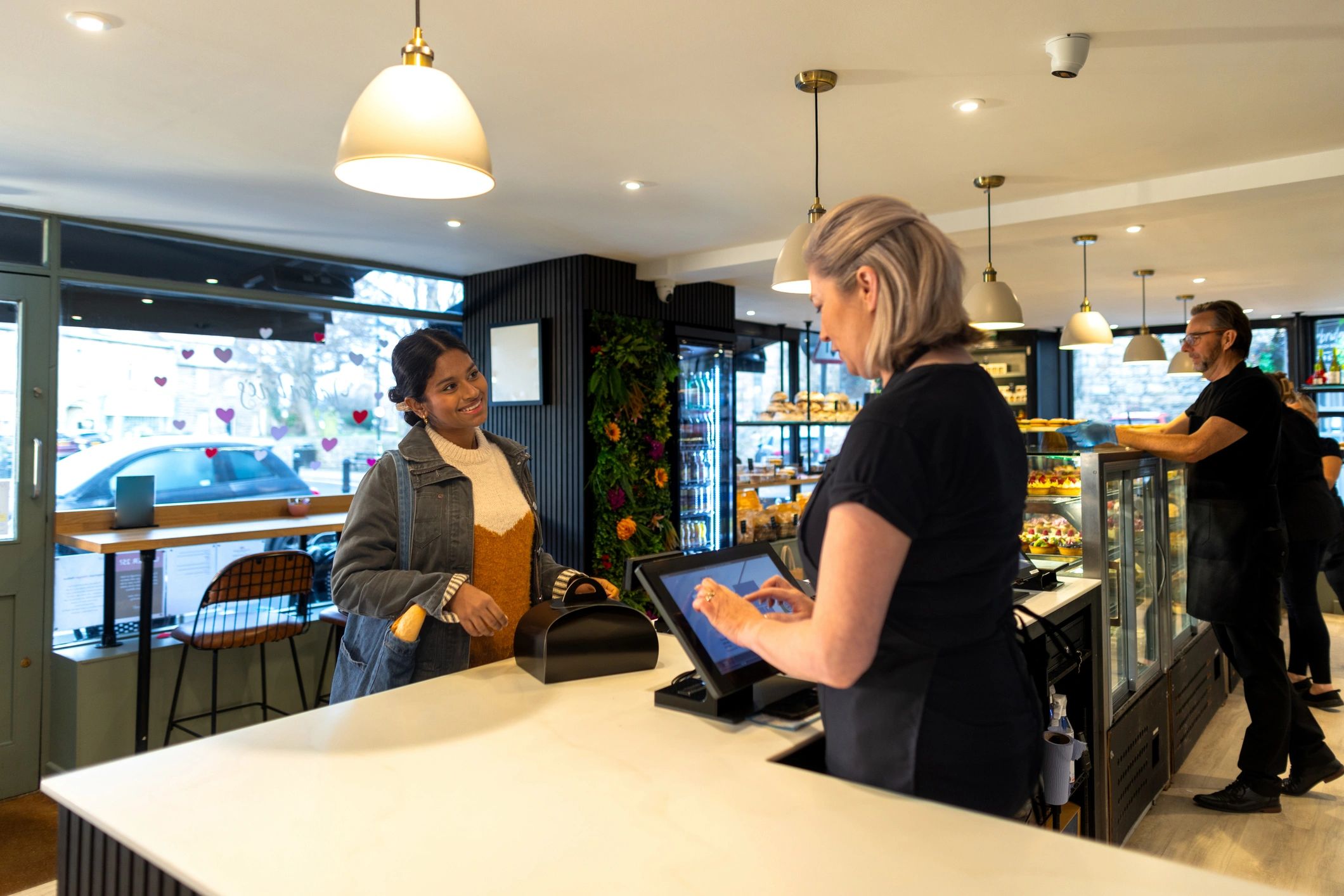 Customer purchasing goods inside a retail bakery
