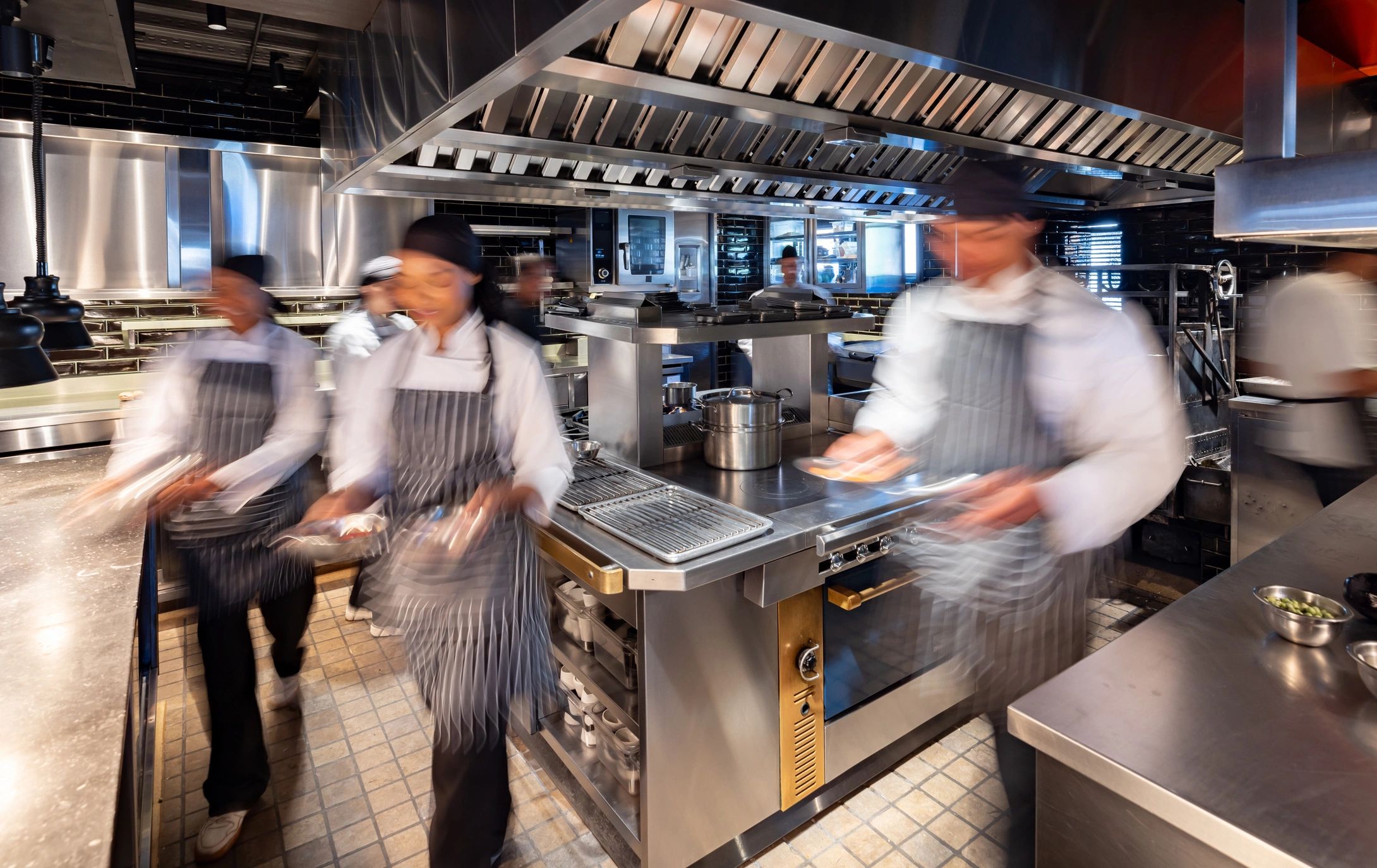 Busy commercial kitchen with chefs at work