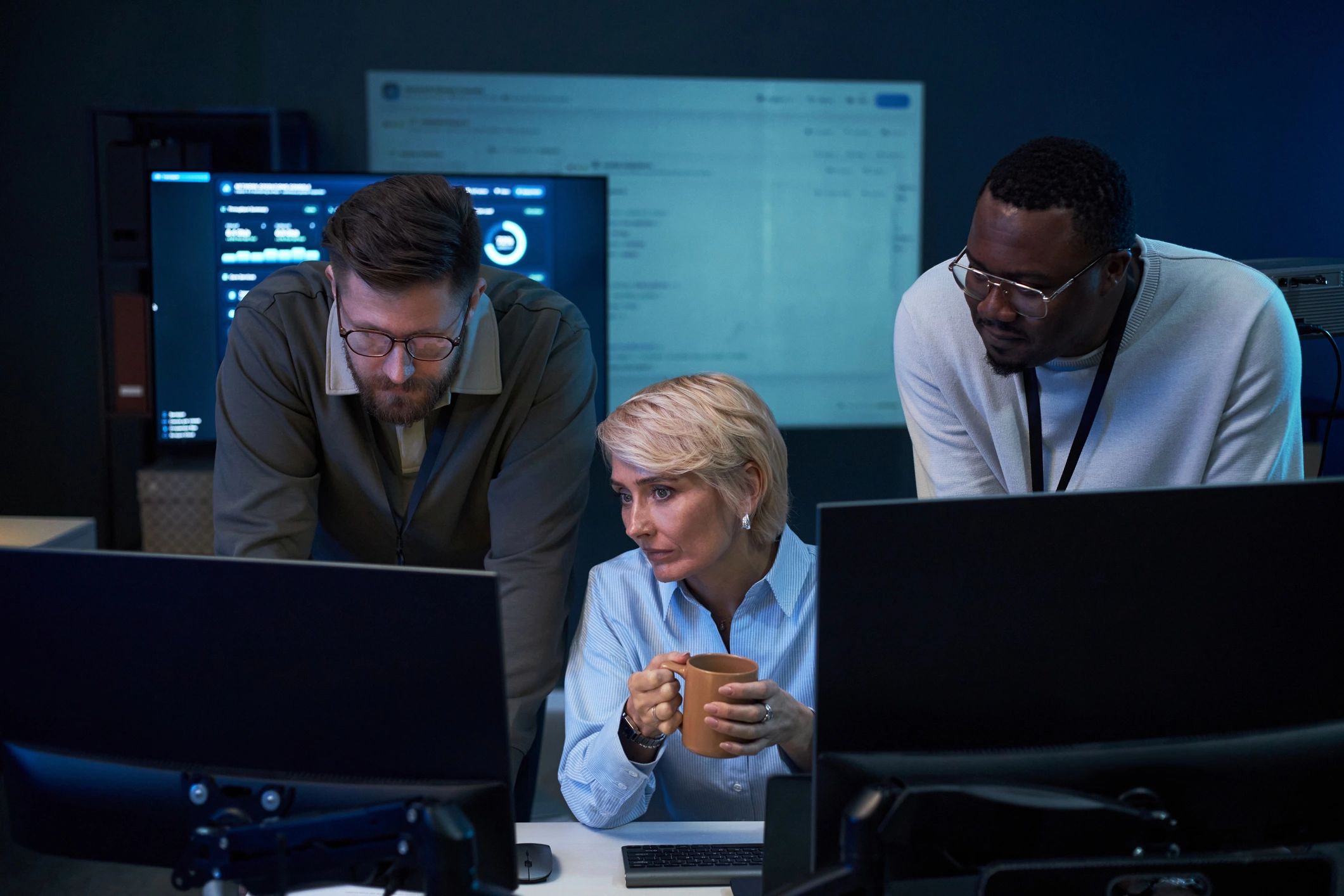 Business professionals monitoring cybersecurity and data operations