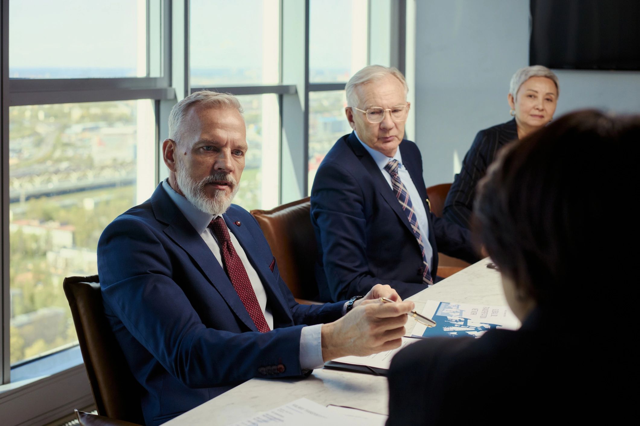 Executives in a boardroom discussing business coverage decisions